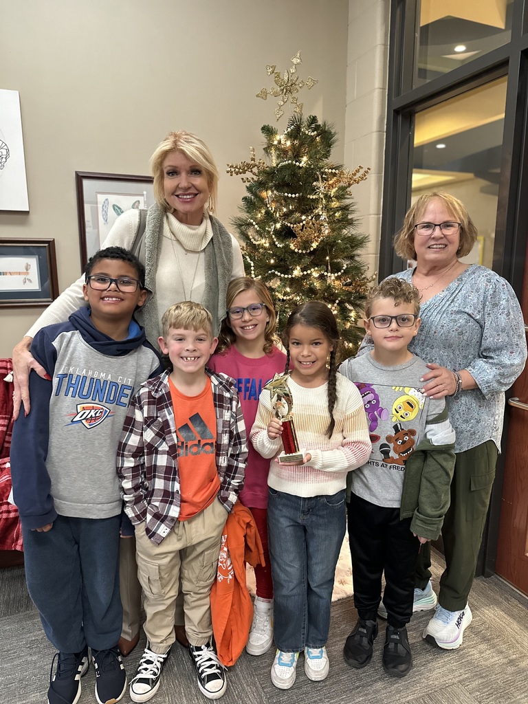 Spelling Bee winners,principal and gifted teacher in front of christmas tree, Left to Right: Hudson Colbert, Syler Aguilera, Ellis Pontikes, Grand Champion: Autumn Davis, Steven Jameson